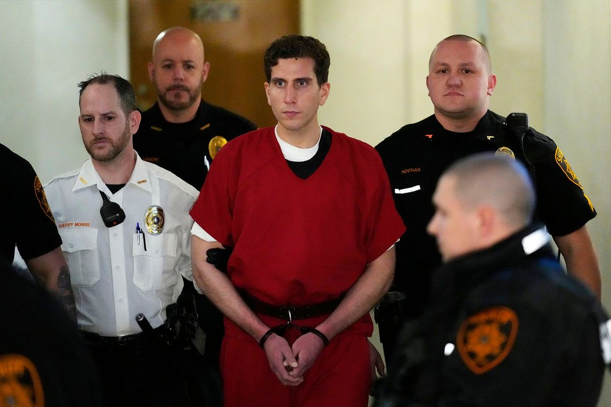 Bryan Kohberger, who is accused of killing four University of Idaho students, is escorted to an extradition hearing Tuesday at the Monroe County Courthouse in Stroudsburg, Pa.  (Matt Rourke/Associated Press Pool)