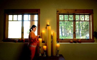 
Lois Miller lights candles in the meditation room in her home she calls Scharelant, which means shared land. She is offering the house for use as a healing center and gathering place. 
 (Kathy Plonka photos / The Spokesman-Review)