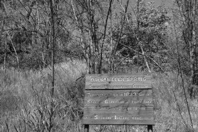 
A wooden sign sits near the entrance to Drumheller Springs Park, commemorating  the site of the first school in Oregon Territory and the place where Chief Spokane Garry taught Protestant religion and farming to the Spokane Indians. 
 (Holly Pickett / The Spokesman-Review)