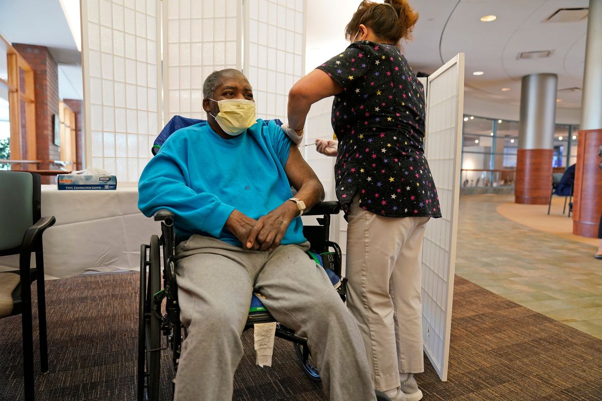 FILE - Edward Williams, 62, a resident at the Hebrew Home at Riverdale, receives a COVID-19 booster shot in New York, Sept. 27, 2021. COVID-19 infections are soaring again at U.S. nursing homes because of the omicron wave, and deaths are climbing too. That