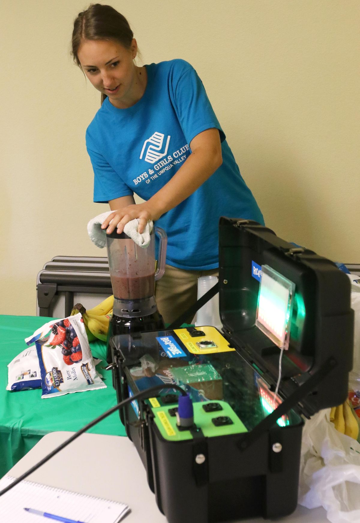Staats makes healthy smoothies in a blender powered by children pedaling a stationary bike in Roseburg, Ore. (Michael Sullivan / Michael Sullivan The News-Review via the Associated Press)