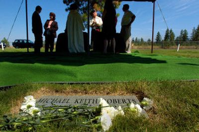 
Flowers left by participants line the grave marker of Michael Keith Roberts after a service Wednesday at Fairmount Memorial Cemetery. 
 (Christopher Anderson / The Spokesman-Review)