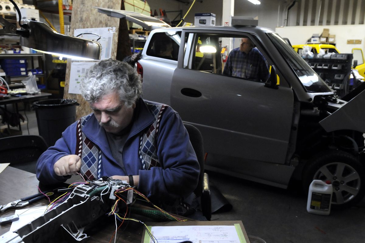 Greg Brown assembles the steering column and controls for a Tango on Friday.  (Jesse Tinsley / The Spokesman-Review)