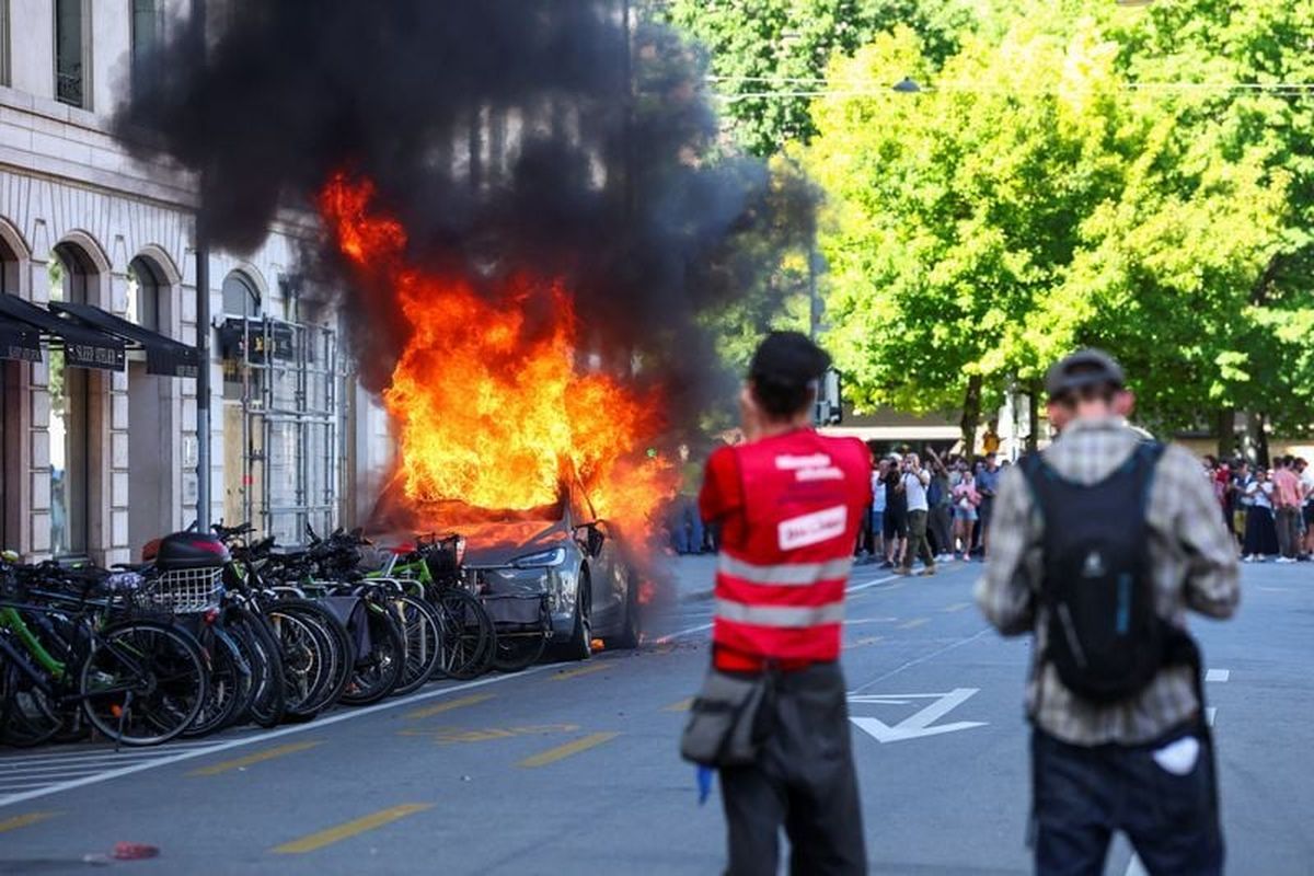 A Tesla car burns during a protest against the upcoming G7 summit in Evian-les-Bains in France, in Geneva, Switzerland on Sunday.  (Reuters )