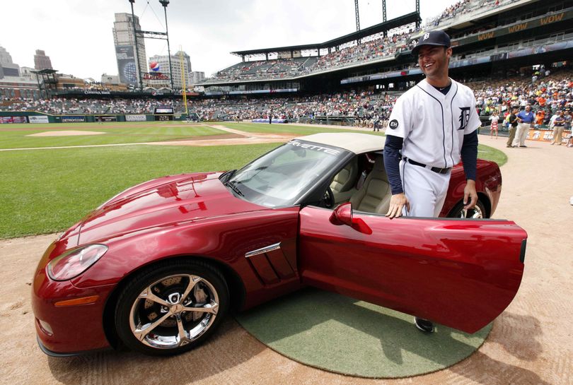 Detroit Tigers pitcher Armando Galarraga smiles while beings presented a Chevrolet Corvette by the manufacturer on the field before a baseball game against the Cleveland Indians  in Detroit Thursday, June 3, 2010.  Galarraga lost his bid for a perfect game with two outs in the ninth inning on a disputed call  at first base by umpire Jim Joyce on Wednesday night. (Paul Sancya / Associated Press)