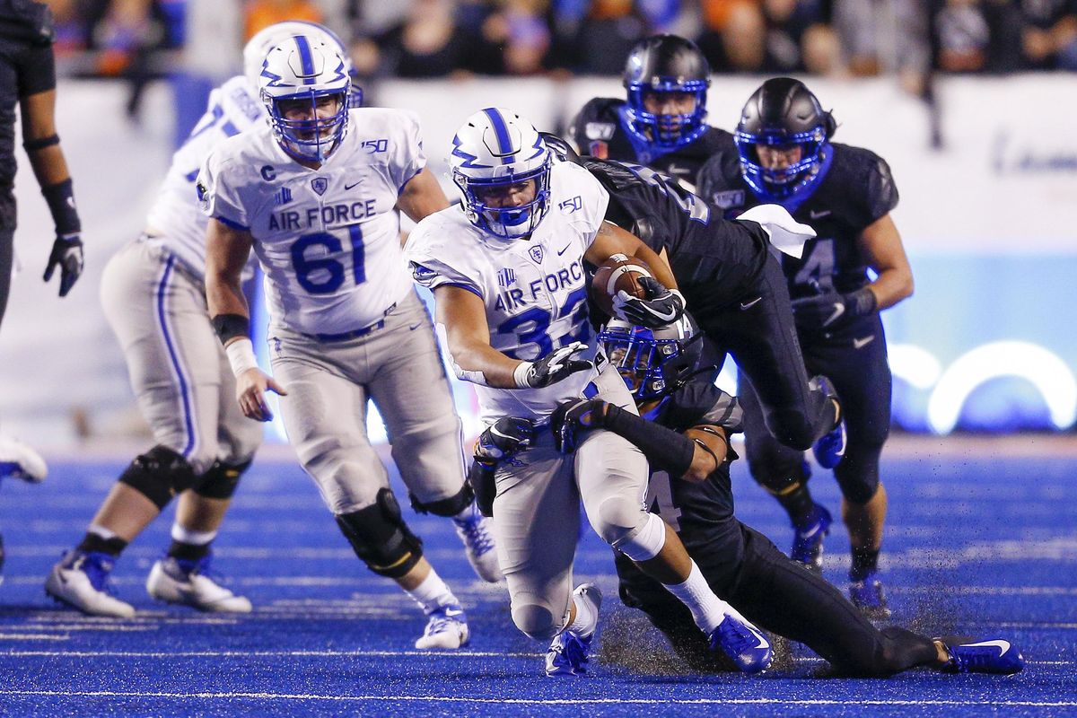 Air Force fullback Taven Birdow (33) fights for more yards as Boise State safety Khafari Buffalo (14) tackles him from behind in the first half of an NCAA college football game, Friday, Sept. 20, 2019, in Boise, Idaho. (Steve Conner / AP)