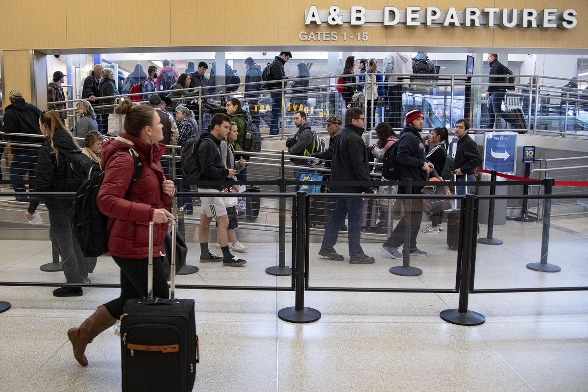 Thanksgiving holiday travelers work their way through security Wednesday for the A and B concourses at the Spokane International Airport. (Colin Mulvany / The Spokesman-Review)