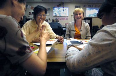 
Ina Matveev, far left, signals thumbs-up after getting through a book with her reading group Monday afternoon. Enjoying the moment with her are, from left, Agnes Wu, Inna Tsyukalo and facilitator Sara Aymerich. 
 (Christopher Anderson/ / The Spokesman-Review)