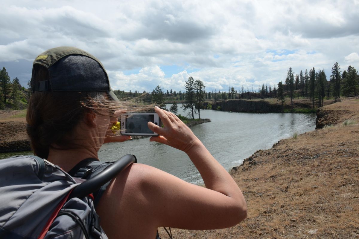 Holly Weiler, who leads volunteer projects for the Washington Trails Association, soaks in the view of Fishtrap Lake from the south loop trail. (Rich Landers / The Spokesman-Review)