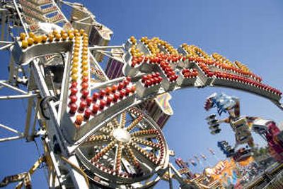 
While riders flip upside down on a neighboring attraction, the Zipper  sits idle Monday after a bolt failed and pin dropped out from one of the ride's cages Saturday at the  Spokane County Interstate Fair. 
 (Holly Pickett / The Spokesman-Review)