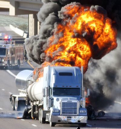 Driver killed: A tanker explodes after being hit by another truck on westbound Interstate 10 near Chandler Boulevard in the Phoenix area Wednesday. Authorities said a milk truck driver was killed when he rear-ended another tanker truck hauling fuel, sparking a huge fire that snarled morning rush hour traffic. Hotels, homes and businesses east of the freeway were evacuated. (Associated Press)