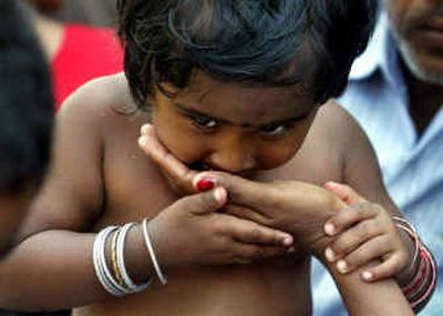 
A girl eats from her mother's hands  at a relief camp in Port Blair, in India's southeastern Andaman and Nicobar islands, on Friday. Both are tsunami victims from Campbell Bay Islands. 
 (Associated Press / The Spokesman-Review)
