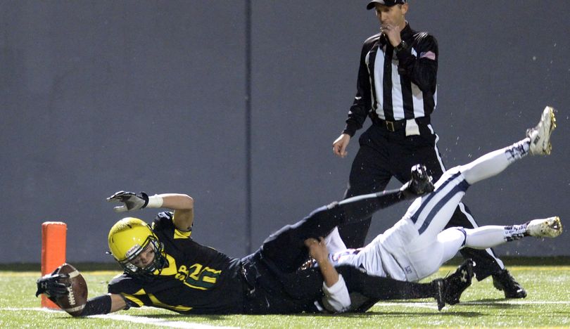 Shadle Park receiver George Pilimai, left, stretches and falls with the ball over the goal line while Mt. Spokane's Zach Vogel hangs on Friday, Oct. 31, 2014 at Joe Albi Stadium.  The reception by Pilimai was the 100th touchdown pass for quarterback Brett Rypien. (Jesse Tinsley / The Spokesman-Review)