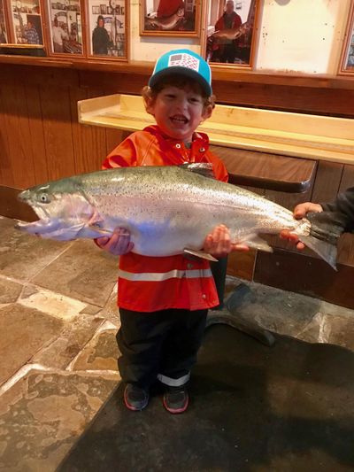 Owen Peterson, 3, holds the 15 pound rainbow trout he caught Tuesday. (Mary Thompson / Courtesy)