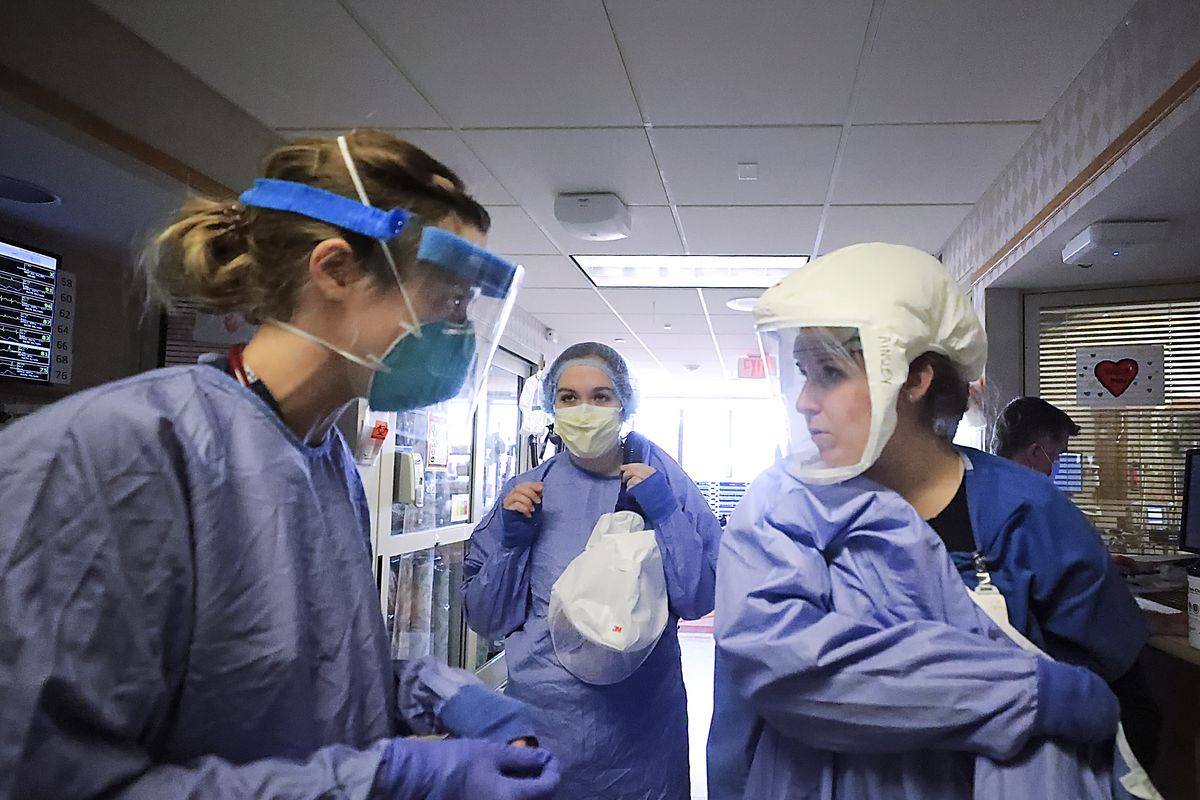 FILE - In this Nov. 5, 2020, file photo, medical staff attending to patients with COVID-19 wear protective equipment in a unit dedicated to treatment of the coronavirus at UW Health in Madison, Wis. Conditions inside the nation’s hospitals are deteriorating by the day as the coronavirus rages through the country at an unrelenting pace.  (John Hart)