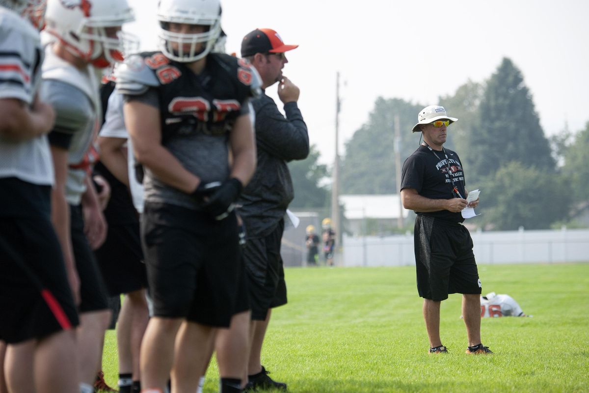 West Valley High School football coach Craig Whitney, right watches practice at the school on Thursday, Aug. 23, 2018. With spring sports canceled due to the COVID-19 pandemic, Whitney, who also coaches golf, is as uncertain as anyone about the fall practice and sports. (Kathy Plonka / The Spokesman-Review)