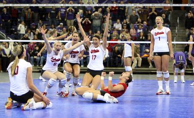 Nebraska players celebrate after defeating Washington in Seattle. (Associated Press / The Spokesman-Review)