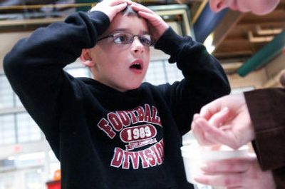 
Tyler Rider, 6, of Spokane reacts to a Madagascar hissing cockroach in a cup, a parting gift for the first 100 children at Susan Rae's Animal Fair.  The cockroaches, in a closeup at right, do not bite, but make a hissing sound when agitated. 
 (Kathryn Stevens photos/ / The Spokesman-Review)