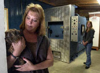 
Genie James, left, holds her Yorkie in the room where she and her daughter, Tara Lowery, right, operate a pet crematorium in the Garwood area. Genie James, left, holds her Yorkie in the room where she and her daughter, Tara Lowery, right, operate a pet crematorium in the Garwood area. 
 (Jesse Tinsley/Jesse Tinsley/ / The Spokesman-Review)