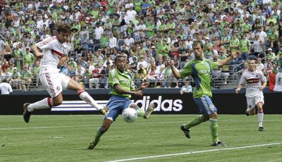 Chicago’s Baggio Husidic, left, shoots as Seattle’s James Riley, center, and Patrick Ianni defend.  (Associated Press / The Spokesman-Review)