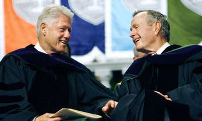 
Former Presidents Bill Clinton and George H. W. Bush smile at each other on the podium at the Tulane University Commencement in New Orleans on Saturday. 
 (Associated Press / The Spokesman-Review)