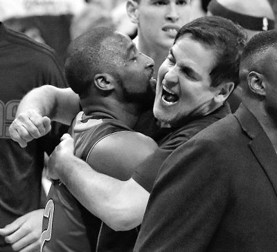 Dallas guard Raymond Felton and owner Mark Cuban hug after the Mavericks pulled off the road upset of Oklahoma City. (Alonzo Adams / Associated Press)