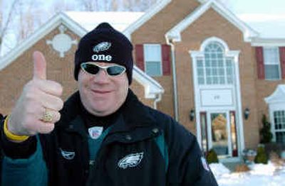 
Philadelphia Eagles fan and season ticket holder Kevin P. O'Donoghue gives a thumbs up to the team's chances in Sunday's Super Bowl last week outside his Glen Mills, Pa., home. Some long-suffering Eagles fans, including O'Donoghue, are so desperate to get to the big game that they're borrowing against their homes to pay for the tickets.
 (Associated Press / The Spokesman-Review)
