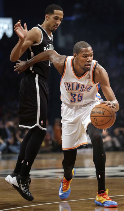 Oklahoma City’s Kevin Durant, right, had his streak of 12 straight games with at least 30 points come to an end in win over Nets. (Associated Press)