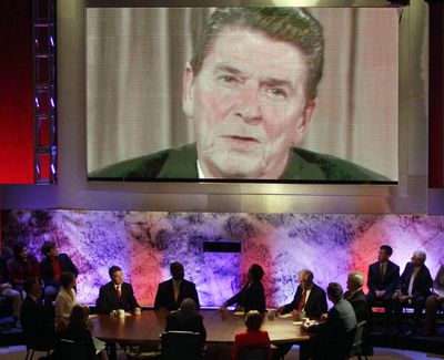 The eight Republican presidential candidates listen as a video of former President Ronald Reagan is played during a Republican presidential debate at Dartmouth College in Hanover, N.H., Tuesday night. (Associated Press)