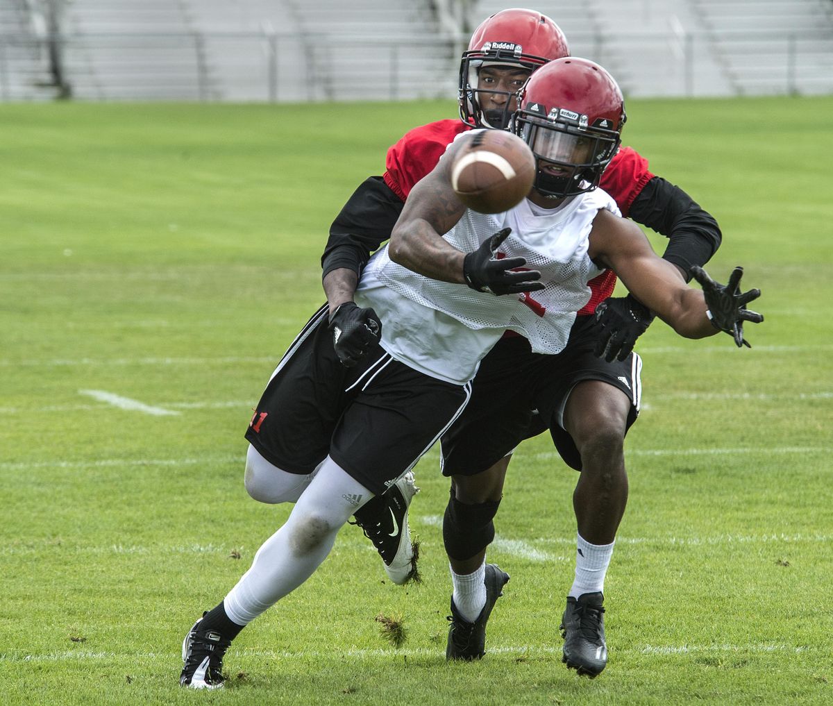 Eastern Washington University receiver Kendrick Bourne, front, fights off the defense of D’londo Tucker during passing drills in Cheney. (Dan Pelle / The Spokesman-Review)