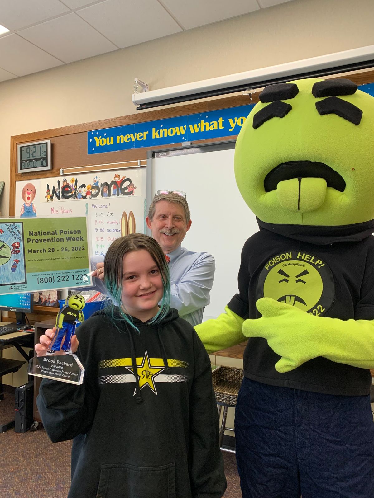 Brook Packard poses with Mr. Yuk and Dr. Scott Phillips from the Washington Poison Center on Tuesday at Finch Elementary.  (Courtesy of Judy Reavis)
