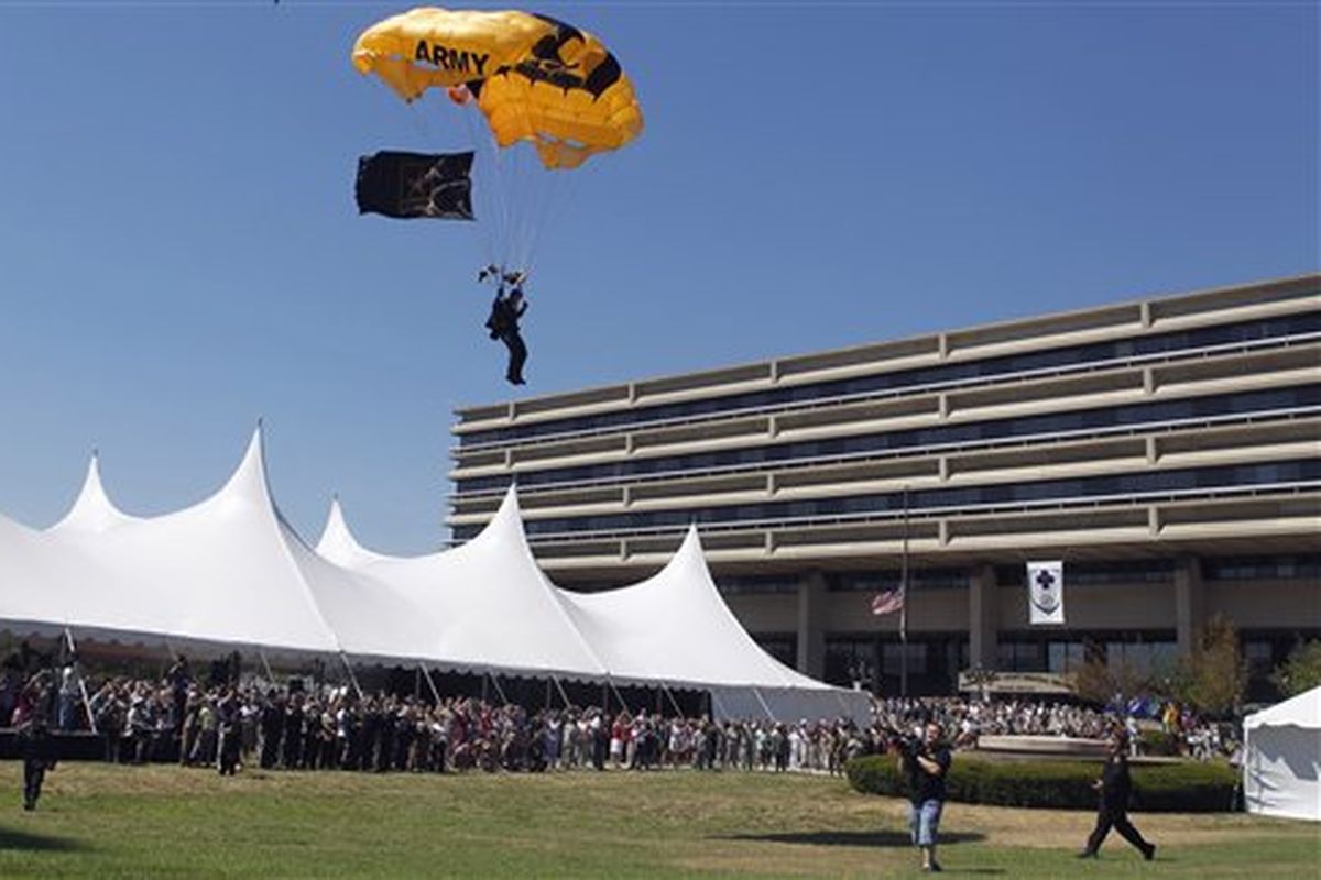 A member of the U.S. Army Golden Knights parachutes onto the front lawn of the Walter Reed Army Medical Center in Washington on Wednesday. Walter Reed Army Medical Center, the military