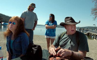 
Darlene Torres, left, the mother of Brenda Matthews Groene, and Ralph McKenzie, father of Mark McKenzie, speak about their children Saturday at the beach in Coeur d'Alene. Standing are Ken Francis, Mark's best friend, and Nena Donnenwirth, Brenda's cousin. 
 (Photos by Jesse Tinsley / The Spokesman-Review)