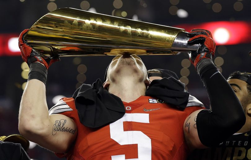 Ohio State's Jeff Heuerman plants a kiss on the championship trophy after the Buckeyes planted the Oregon Ducks in the College Football Playoff championship game. (Associated Press)