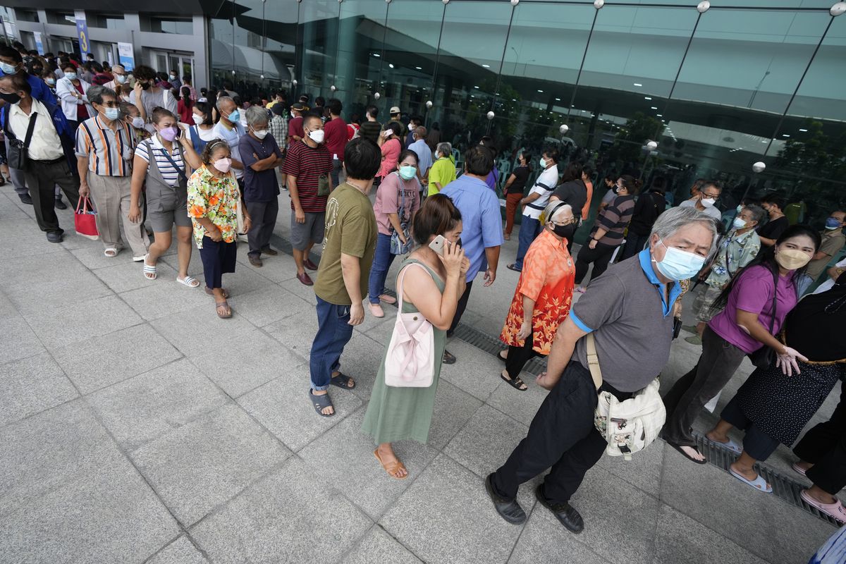 Residents wait on line to receive shots of the AstraZeneca COVID-19 vaccine at the Central Vaccination Center in Bangkok, Thailand, Thursday, July 22, 2021.  (Sakchai Lalit)