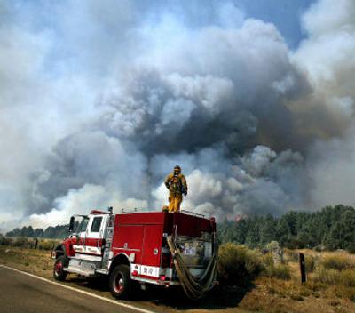 
John Figueiredo, a San Bernardino County firefighter, keeps an eye on the Day Fire on Tuesday. It's one of the largest and longest-burning wildfires in state history, burning more than 143,100 acres.  
 (Associated Press / The Spokesman-Review)