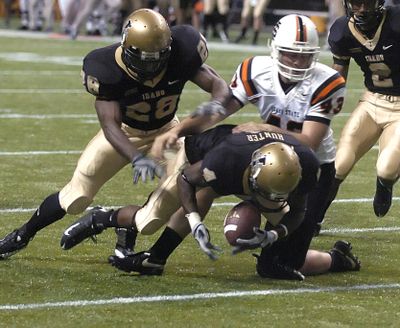 University of Idaho's Eric Hunter falls into the end zone after blocking the first quarter Idaho State punt of Jon Vanderwielen Saturday Sept. 6, 2008 in Moscow, Idaho.  Idaho's Josh Bigler is at left. (AP Photo/Lewiston Tribune, Steve Hanks) ORG XMIT: IDLEW103 (Steve Hanks / The Spokesman-Review)