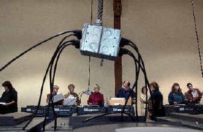 
Pods of voting machines are plugged in for counting as dozens of election workers and observers take part in the recount at the elections office in Spokane. 
 (Brian Plonka / The Spokesman-Review)