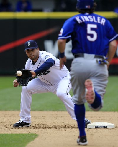 M’s Matt Tuiasosopo, left, is being asked to concentrate on first base and left field this season. (Associated Press)