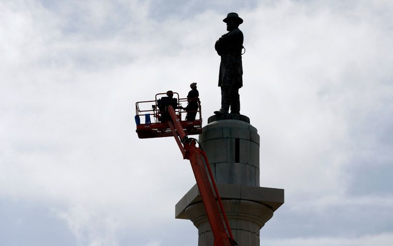 Workers prepare to take down the statue of Robert E. Lee, former president of the Confederacy, which stands over 100 feet tall, in Lee Circle in New Orleans Friday. The city is completing the Southern city's removal of four Confederate-related statues that some called divisive. (AP Photo/Gerald Herbert)