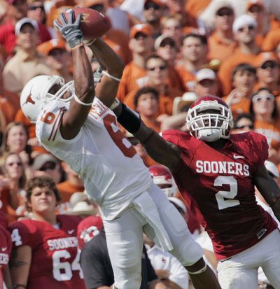 Texas wide receiver Quan Cosby hauls in a 36-yard pass against Brian Jackson during the third quarter Saturday.  (Associated Press / The Spokesman-Review)