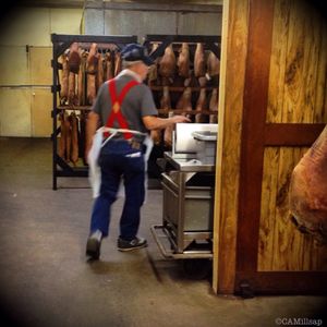 A worker at Benton's Smoky Mountain Country Hams rushes to fill orders. The hams and bacon, smoked in Madisonville, TN,  are shipped around the world (Cheryl-Anne Millsap / Photo by Cheryl-Anne Millsap)