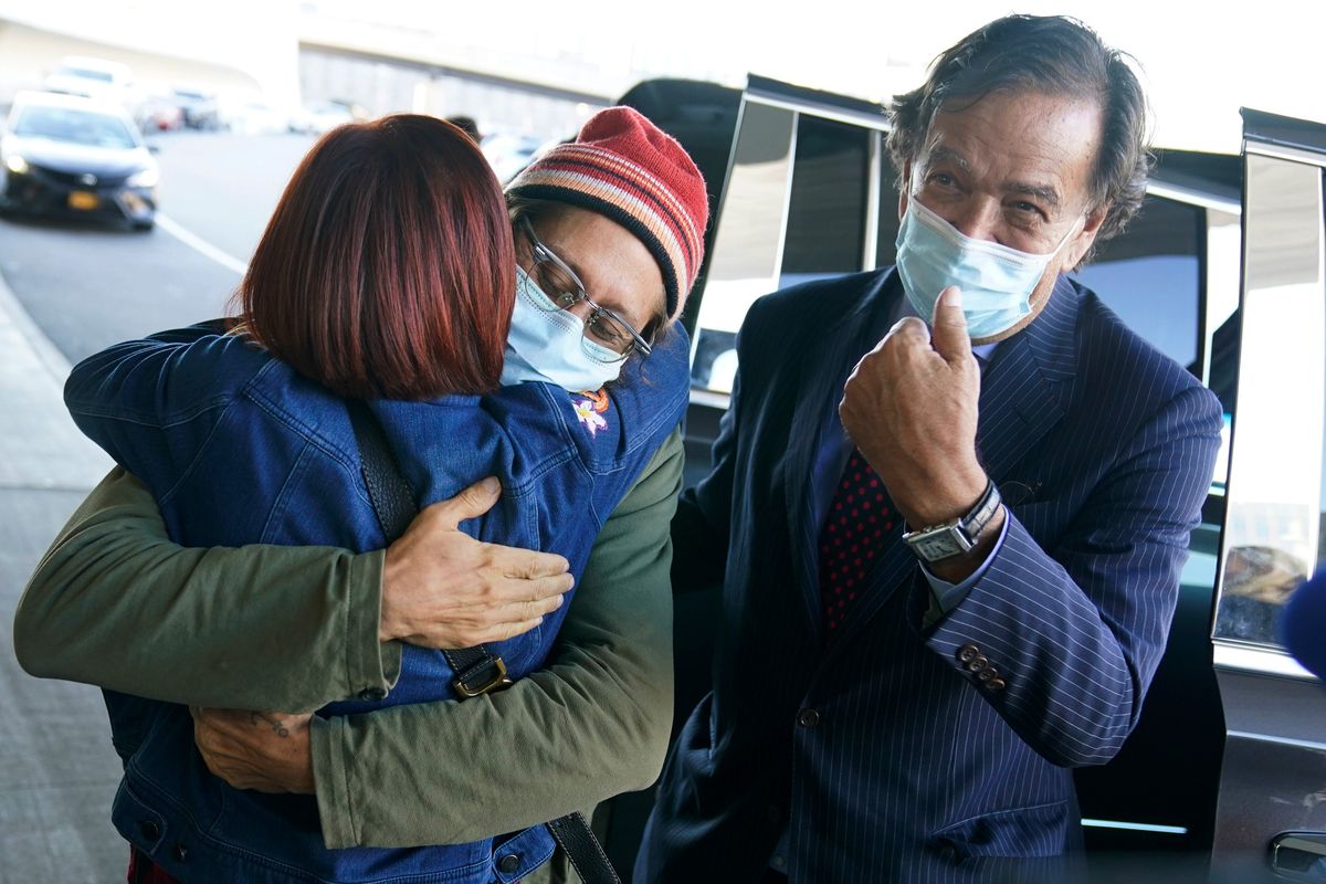 Danny Fenster, center, hugs his mother, Rose Fenster, as former U.S. diplomat Bill Richardson looks on Tuesday at John F. Kennedy Airport in New York.  (Seth Wenig)