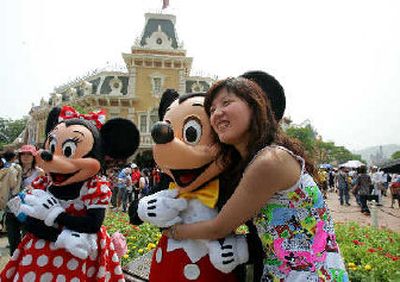 
A visitor hugs Mickey Mouse after the grand opening of the Hong Kong Disneyland on Monday. It is Disney's first vacation resort in China. 
 (Associated Press / The Spokesman-Review)