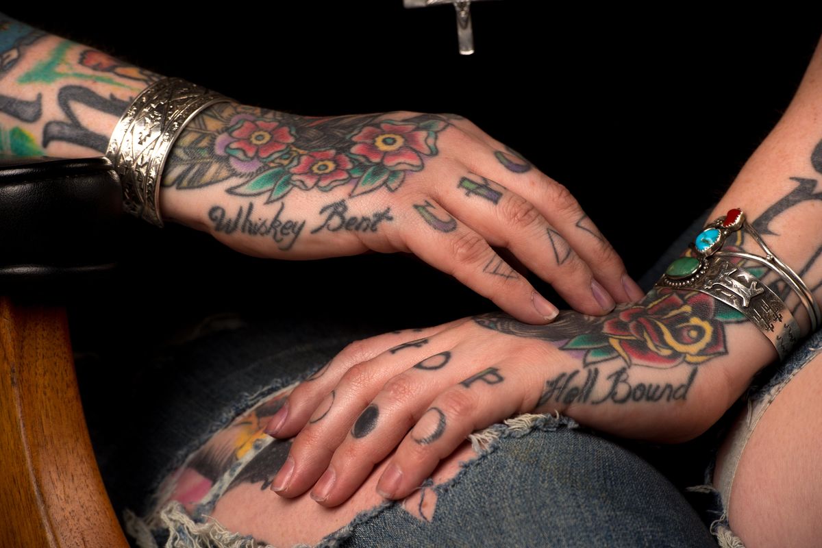 Stephanie Goldsmith, a server and bartender at Hogwash Whiskey Den, has tattoos running from her forehead to her feet. (Tyler Tjomsland / The Spokesman-Review)