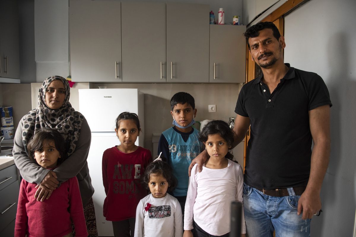Abdul Salam Al Khawien, 37, right, and his wife Kariman, 32, left, pose with their children for a family photo Saturday at their apartment in the northern city of Thessaloniki, Greece.  (Giannis Papanikos)