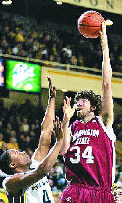 
WSU's Robbie Cowgill puts up a hook shot over Bryce Taylor. 
 (Associated Press / The Spokesman-Review)