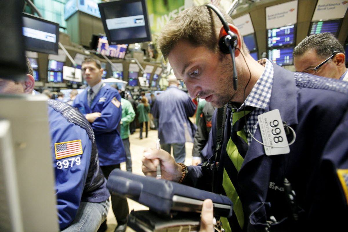 Trader Bradley Silverman, right, works on the floor of the New York Stock Exchange on Friday, Aug. 21, 2009. Stocks are rallying after Federal Reserve Chairman Ben Bernanke told investors what they wanted to hear: The economy is indeed on the verge of recovery. (The Spokesman-Review)