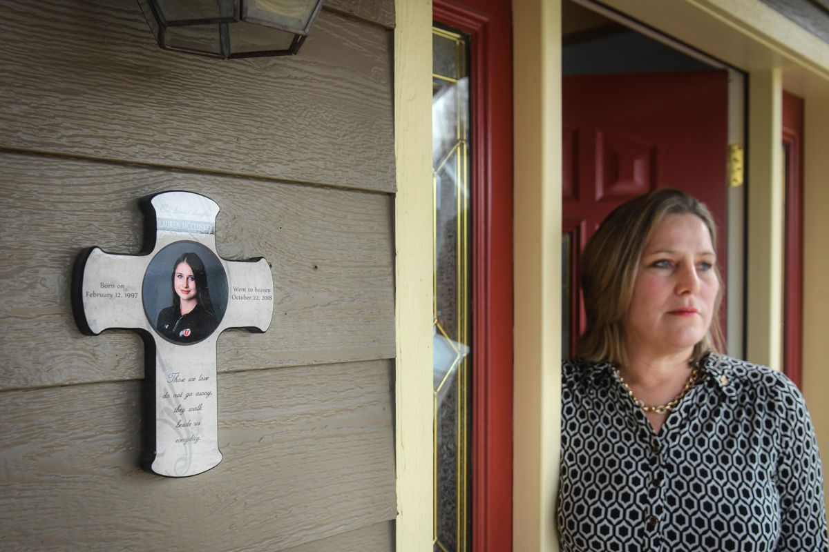 Jill McCluskey stands at the entrance to her Pullman home with a memorial cross to her daughter, Lauren, who was killed in October 2018 by a man  she dated while studying at the University of Utah. (Dan Pelle / The Spokesman-Review)