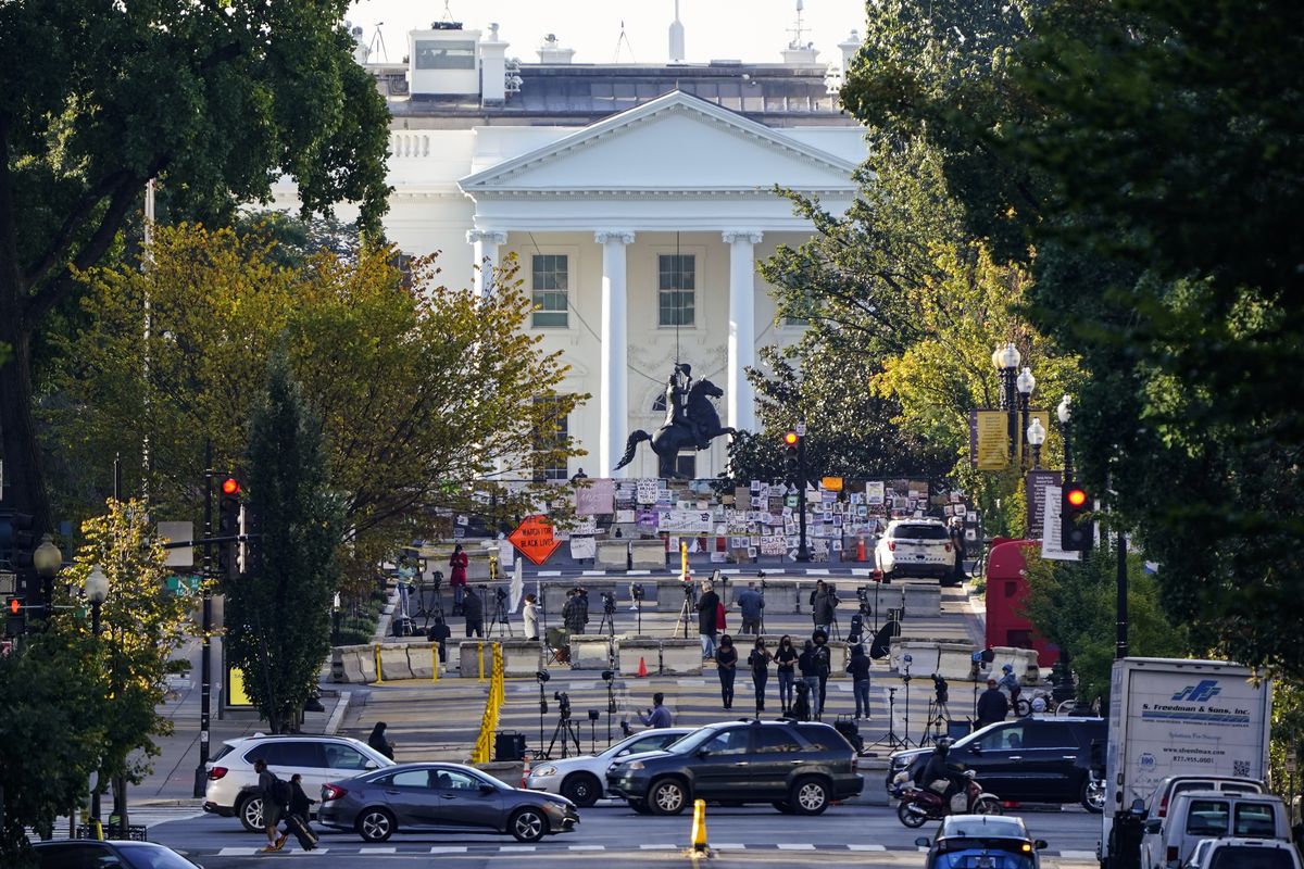 The White House is seen in Washington, early Tuesday, Oct. 6, 2020, the morning after President Donald Trump returned from the hospital where he was treated for COVID-19. Traffic moves along K Street NW as TV crews set up in Black Lives Matter Plaza.  (J. Scott Applewhite)